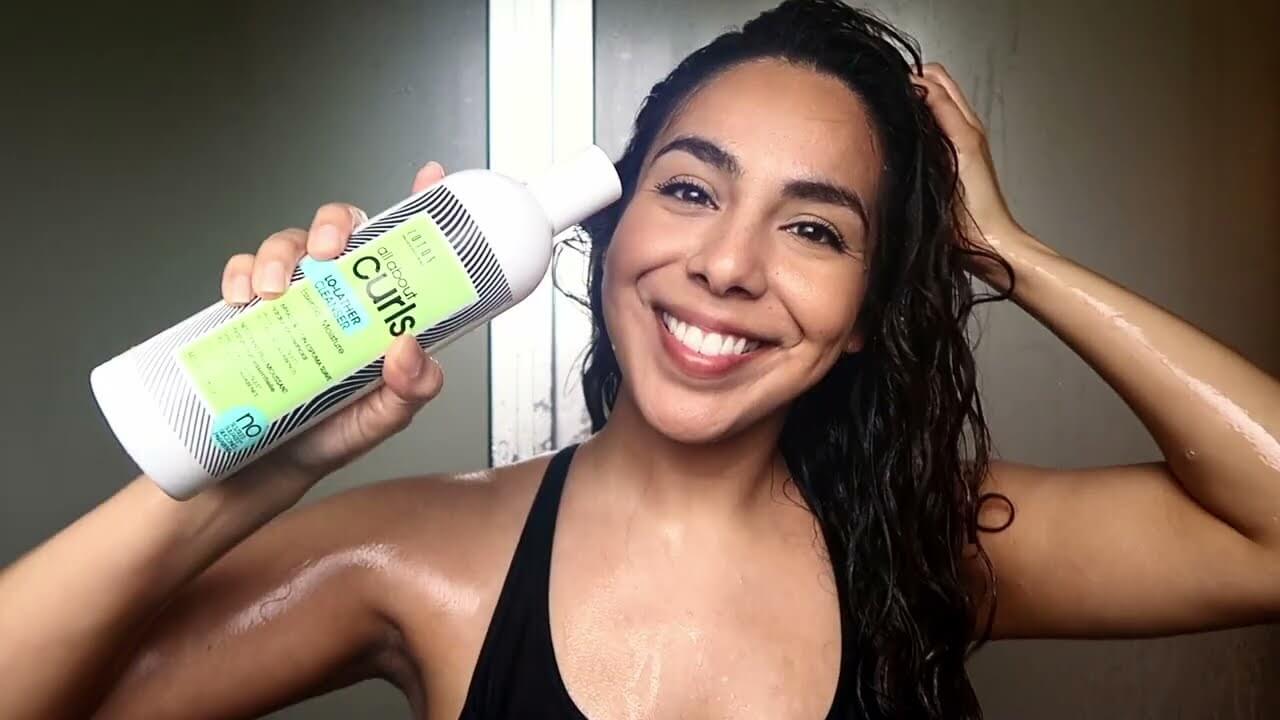 Woman with dark hair washing with lo lather cleanser