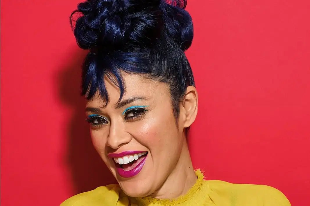 Happy woman with makeup and blue hair up high